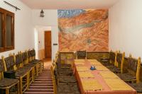 a dining room with a large painting on the wall at Auberge la belle vue dades in Akhendachou nʼAït Ouffi
