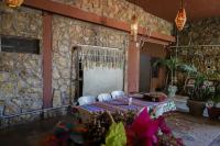 a room with a table and chairs and a stone wall at Hotel Bugambilias ciudad valles slp in Ciudad Valles