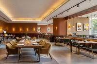 a restaurant with tables and chairs and a bar at YANG TRAVEL Hotel 重庆解放碑洪崖洞店 in Chongqing