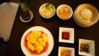 a table topped with plates of different types of food at Manju Hotel Zhoushan New City Children's Park Branch in Zhoushan