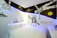 a room with a bed with a drawing on the wall at NL Concept Hotel in Kaohsiung