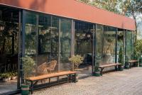 un invernadero con bancos y macetas. en Sunny Camping Sóc Sơn, en Sóc Sơn