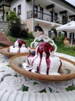 two desserts on a plate on a table at Pensiunea Agroturistica Cerna, Vaideeni - Polovragi in Vaideeni