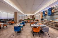 a restaurant with tables and chairs and a cafeteria at Novotel Shanghai Hongqiao International Airport in Shanghai