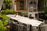 a table with chairs and a white table cloth at Family Hotel Edia-Sandanski in Sandanski