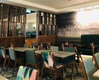 a dining room with tables and chairs and a painting on the wall at Travelodge PLUS Dublin City Centre in Dublin