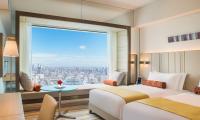 a hotel room with two beds and a large window at The Prince Gallery Tokyo Kioicho, a Luxury Collection Hotel in Tokyo