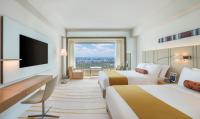 a hotel room with two beds and a flat screen tv at The Prince Gallery Tokyo Kioicho, a Luxury Collection Hotel in Tokyo