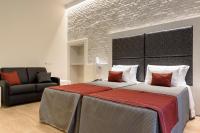 A bed or beds in a room at Navona Luxury Guesthouse
