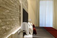 A television and/or entertainment centre at Navona Luxury Guesthouse