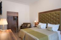 A bed or beds in a room at Navona Luxury Guesthouse