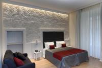 A bed or beds in a room at Navona Luxury Guesthouse