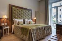 A bed or beds in a room at Navona Luxury Guesthouse
