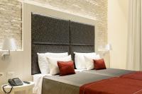 A bed or beds in a room at Navona Luxury Guesthouse