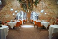 a dining room with tables and chairs and a large window at Hotel San Giovanni Resort in Saluzzo