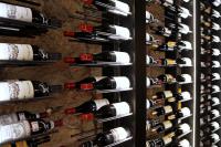 a wine cellar filled with lots of wine bottles at Hotel San Giovanni Resort in Saluzzo