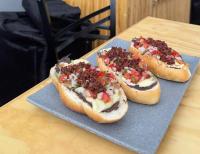 three chili dogs on a plate on a table at Hotel Vinahel in San Cristóbal de Las Casas