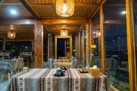 a dining room with a table and chairs at Cloud Valley Háng Đồng in Bắc Yên