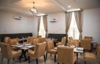 a dining room with tables and chairs in a room at BASLEY HOTEL KUBWA ABUJA Nigeria in Abuja