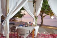 a dinner table under a tent on the beach at Villa Sundancer Lombok By Mey, Ocean View Villa with Infinity pool in Pulau Gilipoh