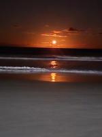 a sunset on a beach with the ocean at Tokaya Club in Ilhéus