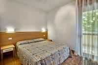 A bed or beds in a room at Residence Columbia