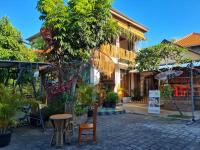a building with a table and chairs in front of it at BBC Suites and Garden in Uluwatu