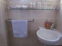 a bathroom with a white toilet and a sink at Caledon 31 in George