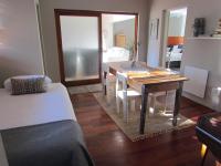 a room with a dining room table and a bedroom at Caledon 31 in George