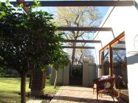 a pergola with a table and a bench in a yard at Caledon 31 in George