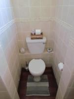 a bathroom with a white toilet in a tiled room at Caledon 31 in George