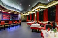 a restaurant with tables and chairs and a bar at The Golden Elite City Near IGI Airport in New Delhi