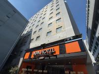 a hotel sign in front of a tall building at APA Hotel Sagamihara Hashimoto Eki Higashi in Sagamihara