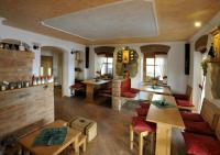 a living room with wooden tables and a brick wall at Sponge Apartmá - Resort Abertham in Abertamy