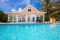 a house with a swimming pool in front of a house at Babylon Reef in North Side