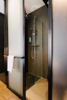 a bathroom with a shower with a glass door at Atypik Hotel in Clichy