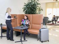 a woman standing next to a woman sitting in a waiting room at Hotel Mercure Graz City in Graz