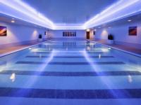 a swimming pool with blue lights in a building at Mercure Sheffield St Paul&#39;s Hotel &amp; Spa in Sheffield