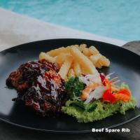 KintamaniにあるBlack Lava Camp Kintamaniの肉とフライドポテトが載った黒い皿