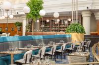 a row of tables and chairs in a restaurant at Hilton Paris Charles De Gaulle Airport in Roissy-en-France