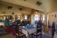 a dining room with a table and a living room at Ksar Ouled Debbab 