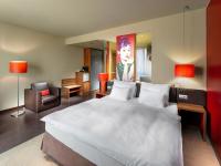 a bedroom with a large white bed and a chair at Clarion Congress Hotel Bratislava in Bratislava