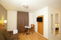 a living room with a couch and a table at Séjours &amp; Affaires Paris Ivry in Ivry-sur-Seine