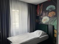 a small bed in a room with a window at Hotel Elsen in Grevenbroich