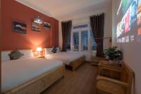 a hotel room with two beds and a window at Moc Thach Hostel Dalat in Da Lat