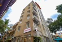 a building with a sign on the side of it at Open Hotel by Olive - Ejipura in Bengaluru