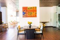 Un comedor con una mesa y sillas y un cuadro. en The 33rd Executive Suites, en Thimphu