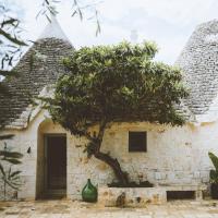 a building with a tree in front of it at TRULIVO in Monopoli