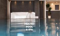 a hotel lobby with a heated pool and spa at GARNI&#39; FOCI in Riva del Garda