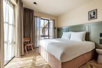 a hotel room with a large bed and a window at Metzlr House in Haarlem